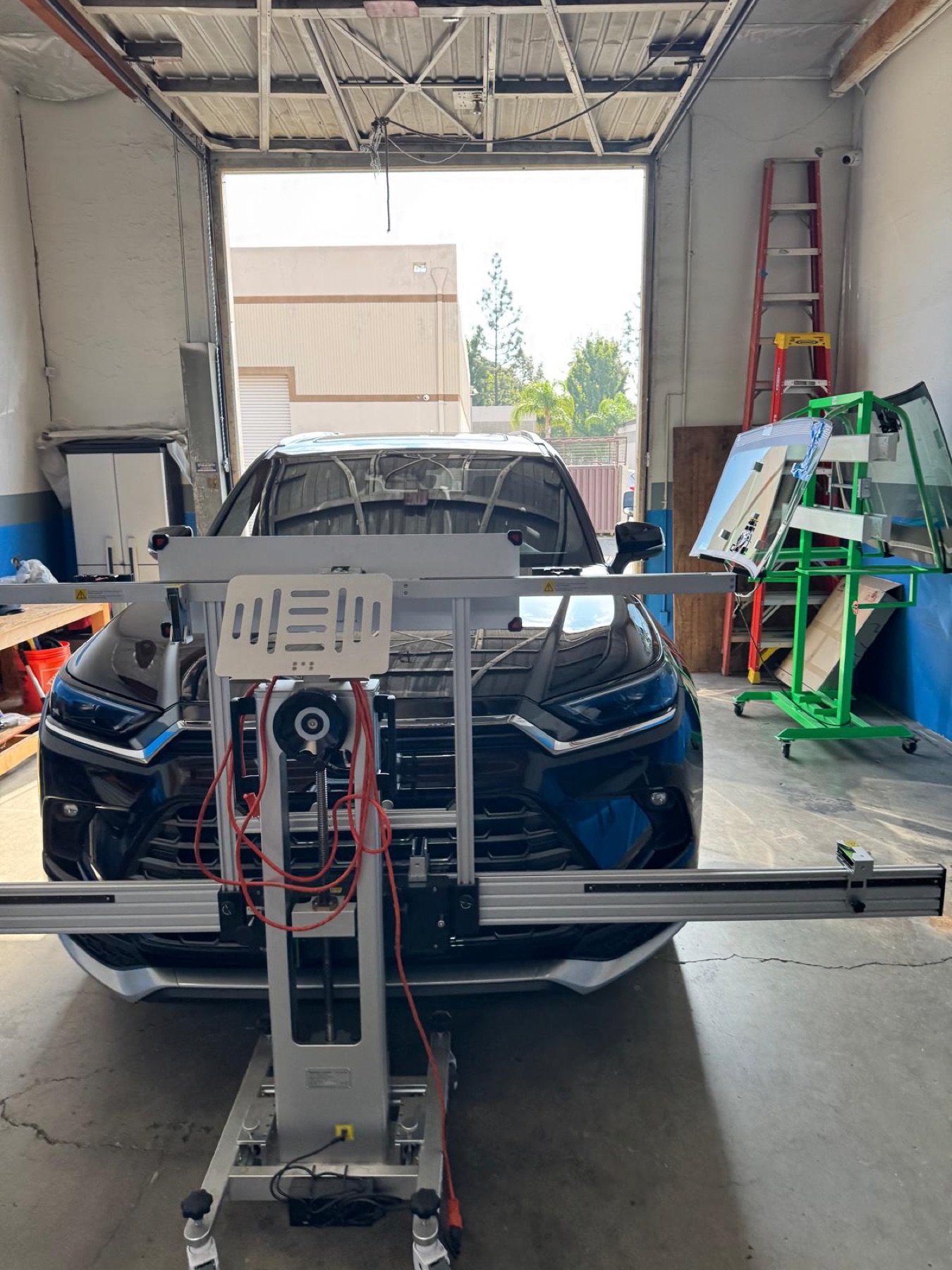 Vehicle aligned with professional ADAS calibration equipment
