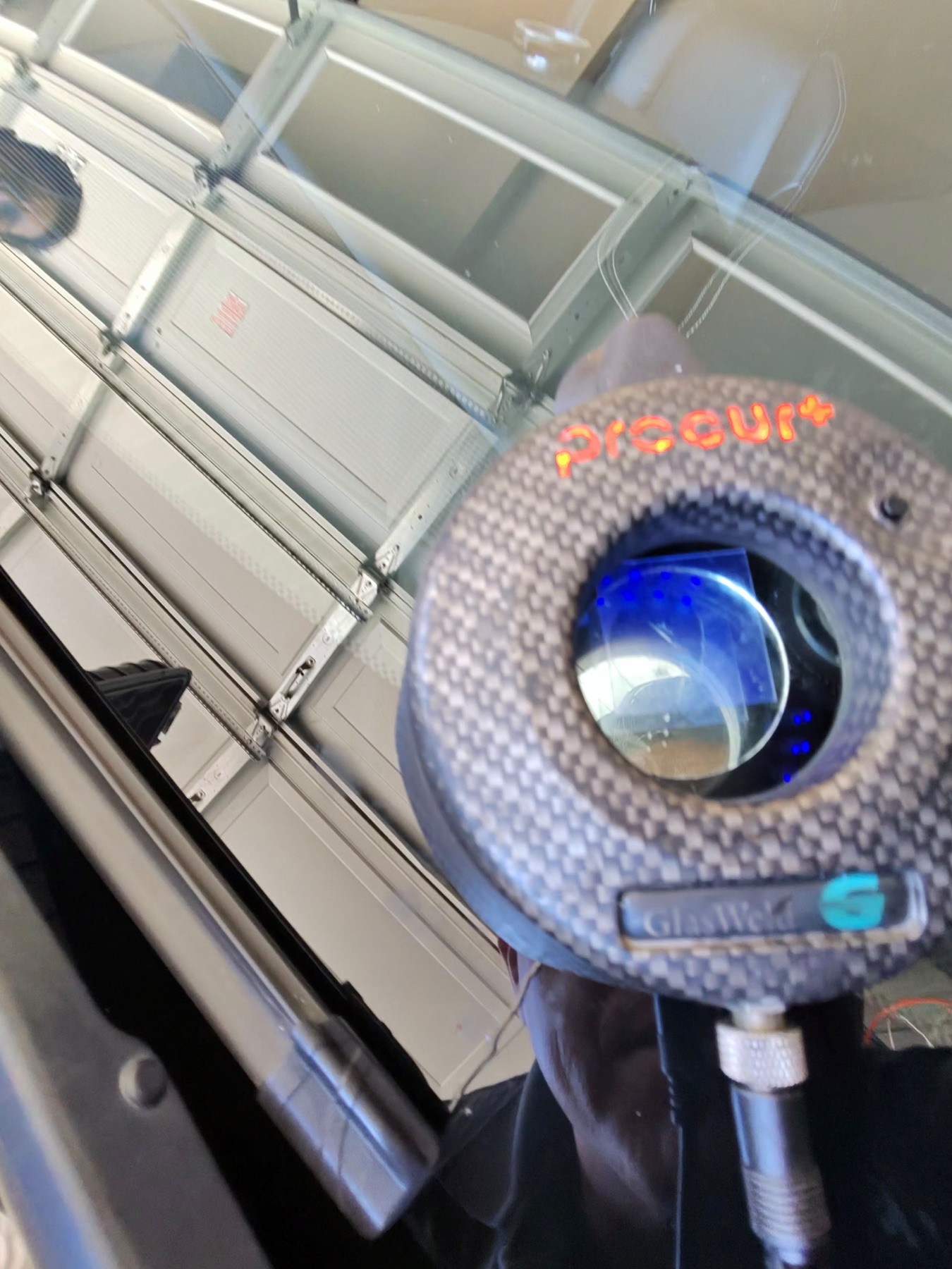 Windshield chip repair inspected with a magnifying lens